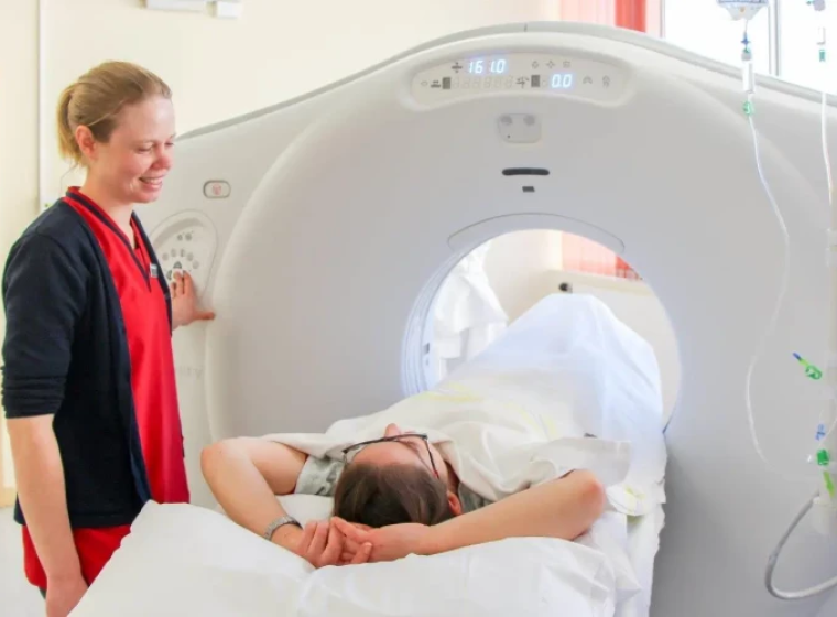 An MIT prepares a patient for medical imaging.