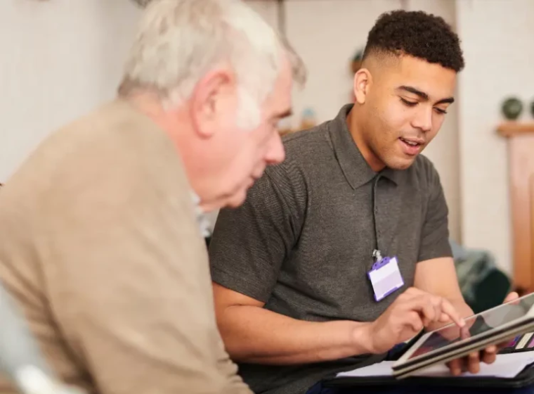 A clinical psychologist helping an elderly person.