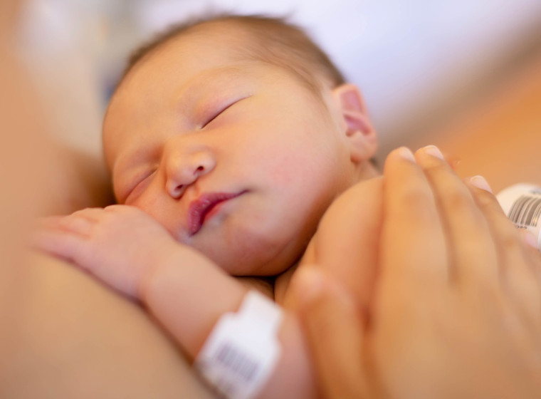 Photo showing close up of face of sleeping newborn baby.